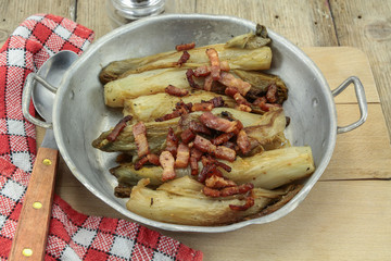 braised endives with bacon in a dish