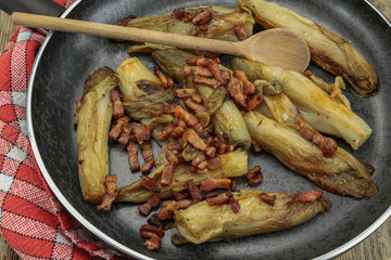braised endives with bacon in a dish