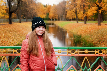 Girl is walking in the autumn Park