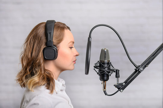 Girl with a studio microphone, Radio presenter, singer and blogger, voice acting for films. Radio ether, or blogger.