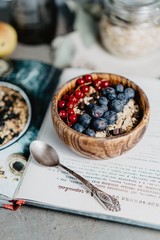 Flakes with blueberries and raspberries in wooden plates