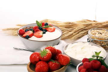 Tasty homemade granola served on table. Healthy breakfast with a bowl of oatmeal with banana, blueberries, strawberries and healthy food for Breakfast