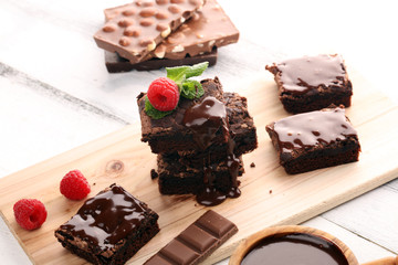 chocolate brownie cake dessert with raspberries and spices on a wooden background.