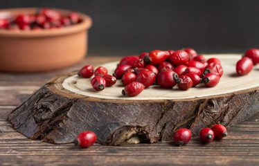 Rosehip fruits on wood, rich in vitamin C, immunity protection and antioxidant