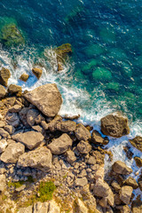 Aerial of ocean waves hitting rocks