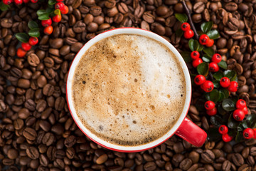 Red coffee cup with red berries with roasted beans