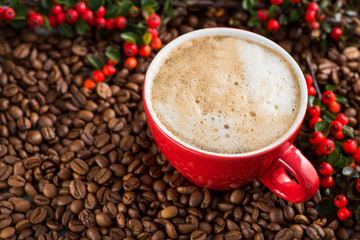 Red coffee cup with red berries with roasted beans