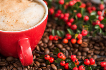 Red coffee cup with red berries with roasted beans
