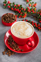 Cappuccino or latte with milk foam in a red cup