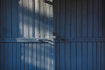 old wooden gate with metal lock