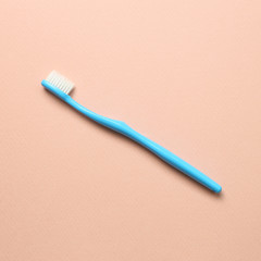 Blue toothbrush on pink background