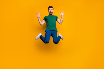 Fototapeta na wymiar Full size photo of astonished guy hear wonderful black friday discounts information impressed jump scream wow omg wear modern youth clothing isolated over yellow color background