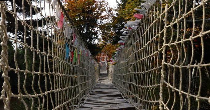 Beskids Himalayan sidewalk, deep in nature Skywalk wooden construction&nbsp; hitting by strong wind tree colored flags during a sunny, strong wind, autumn day captured in Radhost Pustevny area 4k 60fps