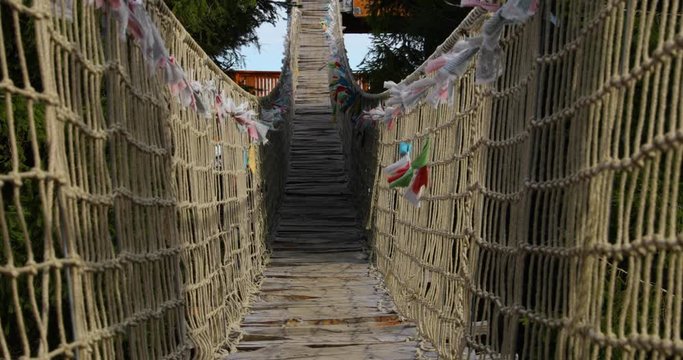 Close view Himalayan sidewalk, deep in nature Skywalk wooden construction&nbsp; hitting by strong wind tree colored flags during a sunny, strong wind, autumn day captured in Radhost Pustevny area 4k 60fps