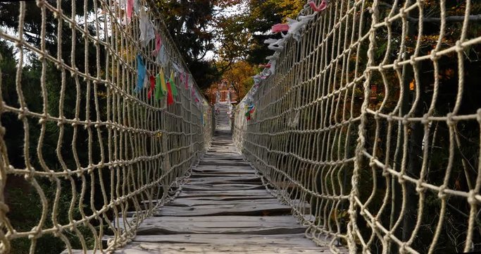 Beskids Himalayan sidewalk, deep in nature Skywalk wooden construction&nbsp; hitting by strong wind tree colored flags during a sunny, strong wind, autumn day captured in Radhost Pustevny area 4k 60fps