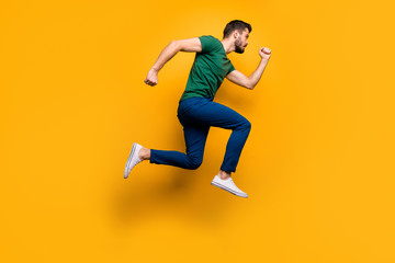 Fototapeta na wymiar Full length profile side photo of serious focused guy jump run fast want buy spring black friday discounts wear casual style outfit isolated over yellow color background