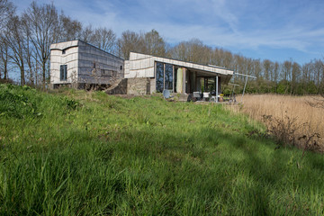 Fototapeta na wymiar Ecological self contained house. Lake and villa. Modern Dutch architecture. Netherlands. Dwingeloo