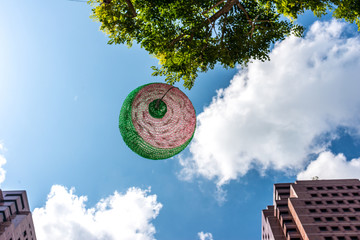 Christmas ornaments mysteriously floating in the air along public streets