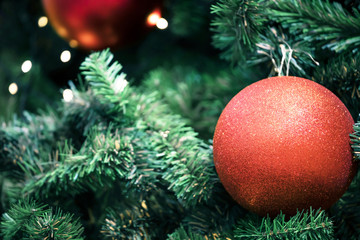 Closeup of bauble colorful variety hanging from a decorated christmas tree on blurred of lights with decorated tree, sparkling and bokeh background. copy space for your text. Christmas Tree Decoration