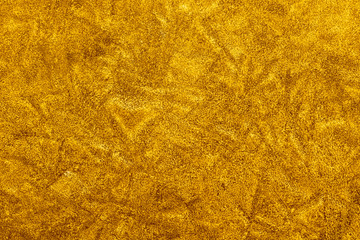 orange decorative plaster background, ginger stucco wall with copyspace, abstract wallpaper close up ,yellow texture macro