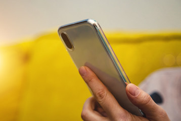 young woman writes text on smartphone closeup