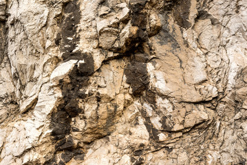 Texture of natural layered limestone surface rock, quarry limestone, limestone hill
