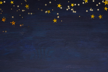 Dark-blue wooden background with golden stars with copy space for text. - obrazy, fototapety, plakaty