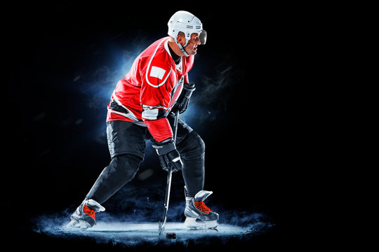 Ice Hockey Player Isolated On Black Background