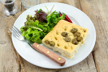 foccacia with olives on a plate