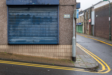 High Street Shops closing down with shutters closed, decline in shopping in Wales, United Kingdom