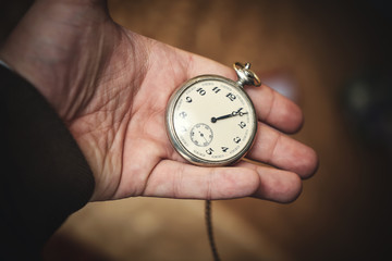Rare old-time watch in the hand of a young man