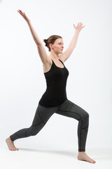 Fototapeta premium woman in gym clothes is doing some streching exercises