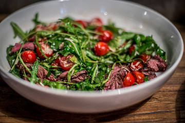 Hanging tender salad / tuscan herbs / arugula / parmesan / blistered cherry tomatoes