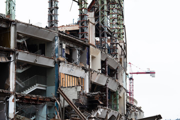 Demolition of the arena. Old metal frame of the building, destroyed walls.