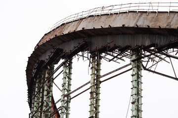 Demolition of the arena. Old metal frame of the building, destroyed walls.