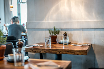 rustic country style restaurant with white walls,  table seating and lamps