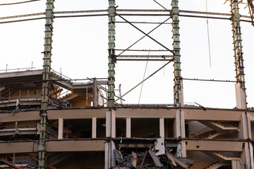Demolition of the arena. Old metal frame of the building, destroyed walls.