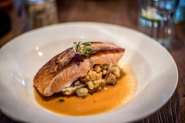 Pan roasted Norwegian salmon / crushed potatoes / tomato / herb shellfish broth