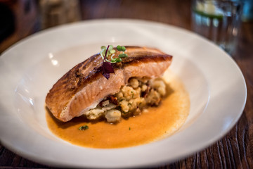 Pan roasted Norwegian salmon / crushed potatoes / tomato / herb shellfish broth