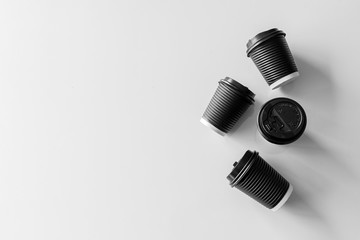 black paper cup coffee on white table background