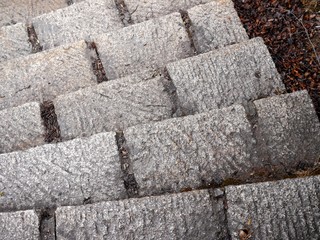 Top view photo of an outdoor staircase with steps made of large stone blocks.