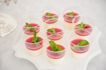 strawberry pana cotta on a white plate in a candy bar