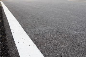 asphalt road with white edge line