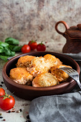 Tender meat meatballs in tomato sauce in a stylish clay plate. Vertical photo