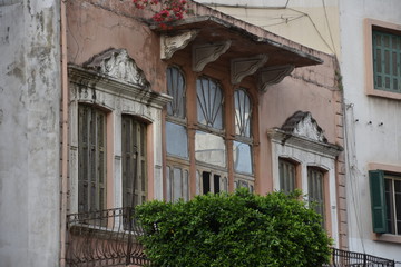 Naklejka premium Aged Pink Townhouse Facade with Balconies, Beirut, Lebanon