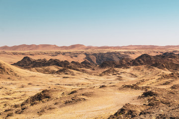 Fototapeta na wymiar Kuiseb Canyon with red dunes in the background, moonscape, Namib desert, Namibia, Africa