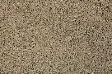 Cement textured coating, texture, background. Structural plaster, rough, uneven surface in brown or gray color. Modern exterior cladding of multi-story buildings
