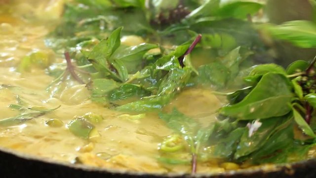 Cooking green curry in pan, Thai famous food