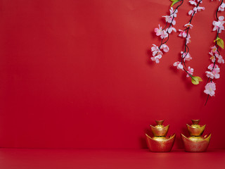 Chinese gold ingot on red background