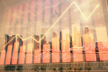 Forex chart on cityscape with tall buildings background multi exposure. Financial research concept.